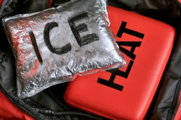 Ice pack and heating pad side by side in a gym bag, ice vs. heat for recovery