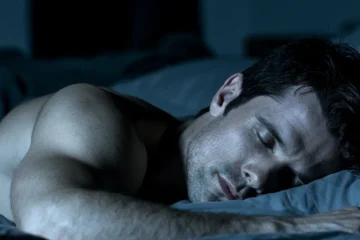 Man asleep during the deep sleep phase when muscle growth and testosterone release occur